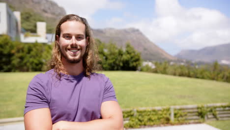 Caucasian-male,-smiling-with-arms-crossed-in-garden,-copy-space