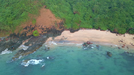 aerial view of waves crashing on rock cola beach goa india 4k