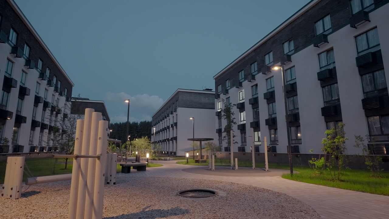 Evening Courtyard Exercise Zone With Fitness Poles And Benches On Pebble Ground, Lit Pathways Winding