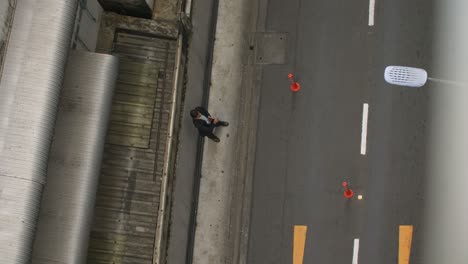 business man standing next to road