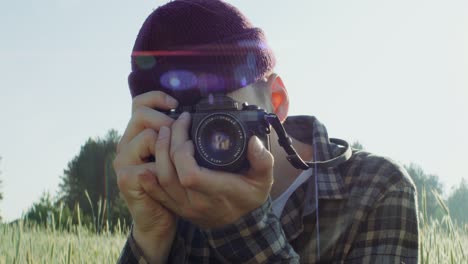 man taking a picture in a field