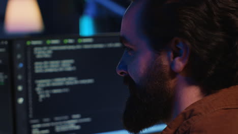 upbeat teleworking it professional in apartment writing lines of code, close up,