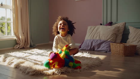 happy child playing with a toy dinosaur