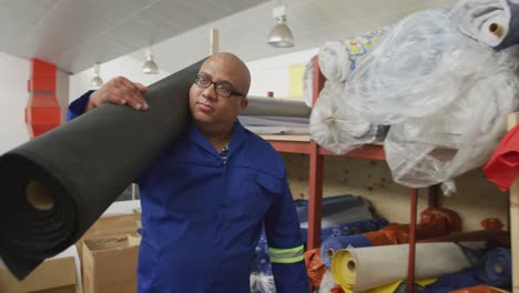 worker carrying a carpet