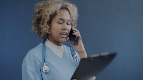 nurse on phone with clipboard