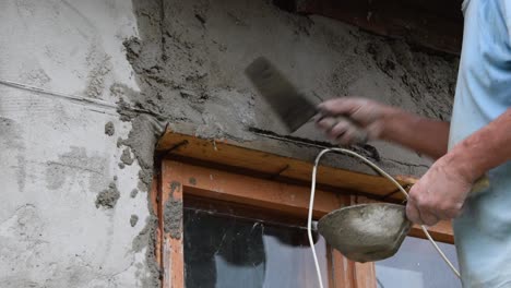 Close-up-of-a-construction-worker-applying-cement-mortar