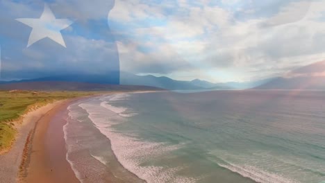 video compuesto de la bandera de texas ondeando contra la vista aérea de la playa y las olas del mar