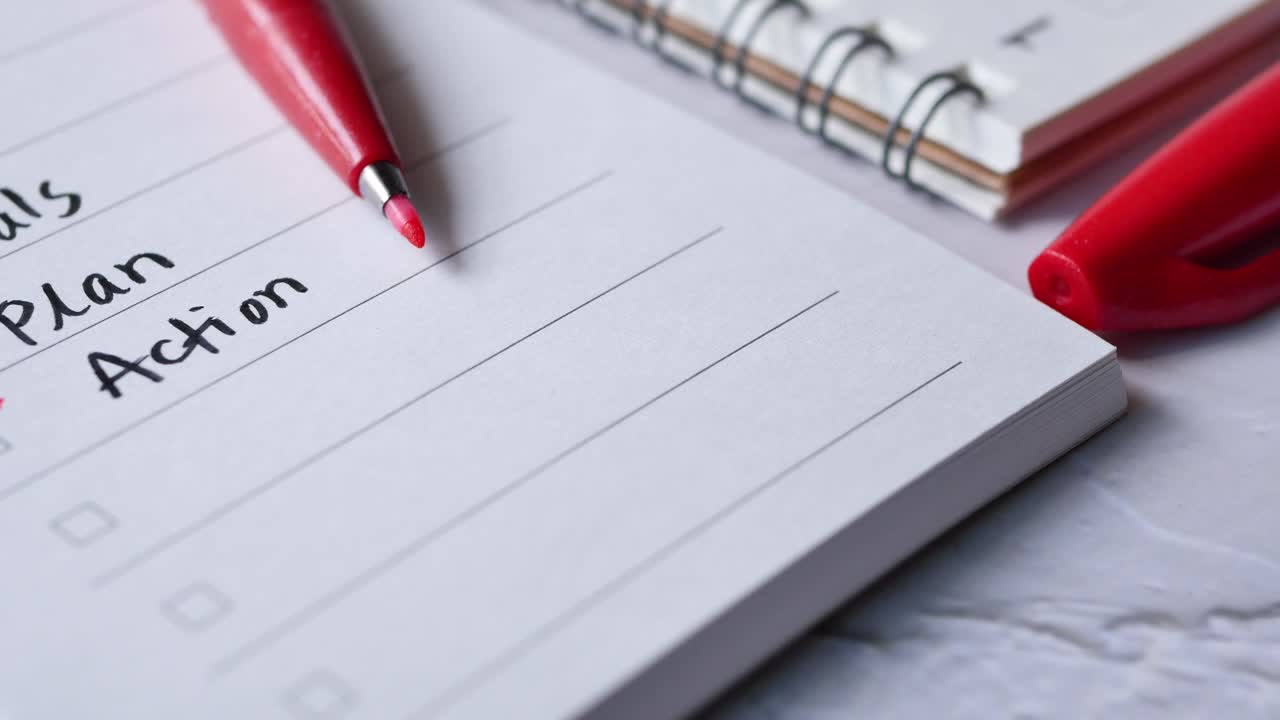 Tick mark on planning goals on notepad ,