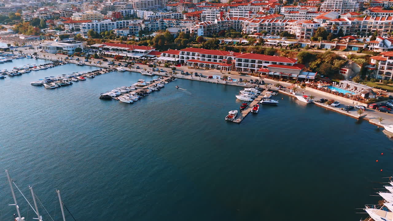 Approaching the piers with water transport at the berths. Lots of hotels on the slopes at backdrop. Sveti Vlas, Bulgaria