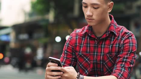 Handheld-view-of-Vietnamese-man-with-cell-phone