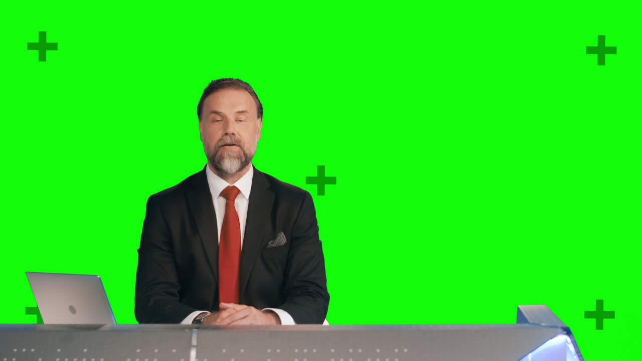 Green Screen Background: Live News Studio with Professional Male Anchor Reporting on the Events of the Day. Television Channel Newsroom Concept. Chroma Key Background with Tracking Markers