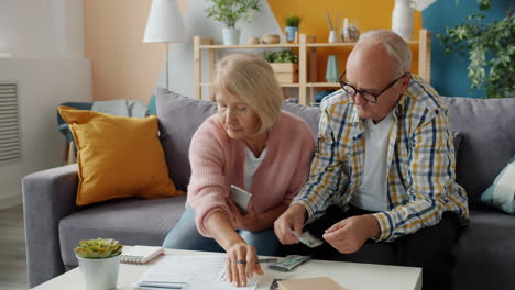 elderly couple reviewing finances at home