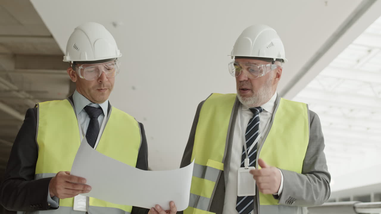 Two Builders Discussing Project in Construction