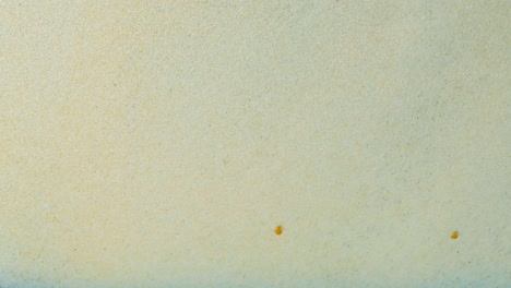 light beige textured surface with spots