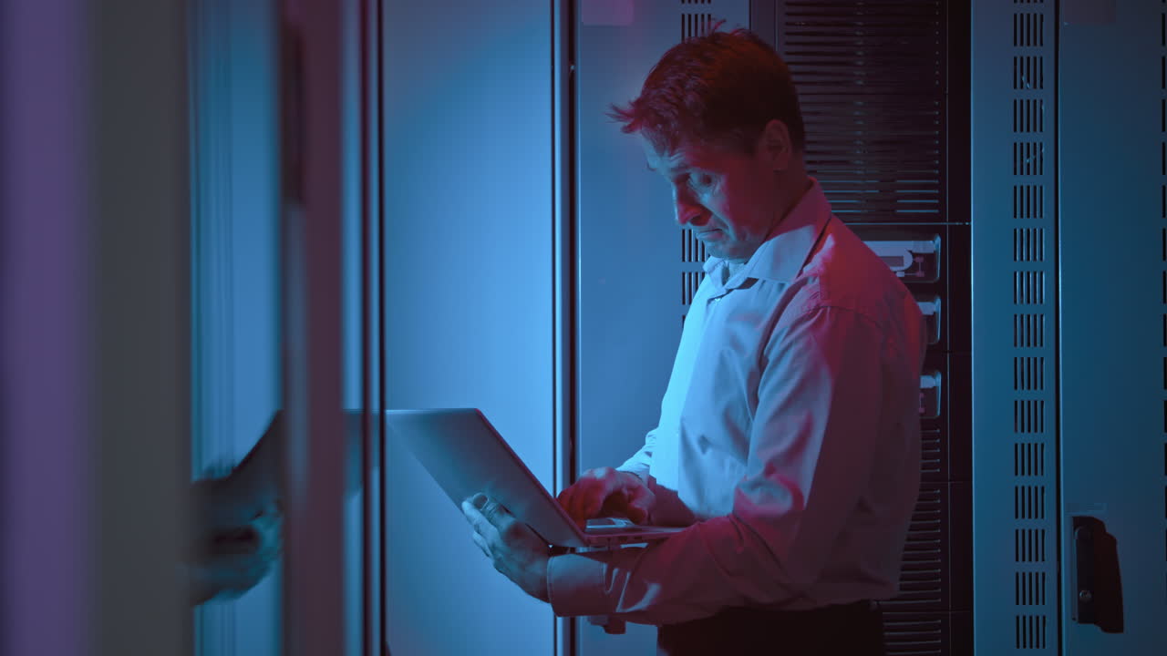 Middle-Aged Data Center Technician at Work