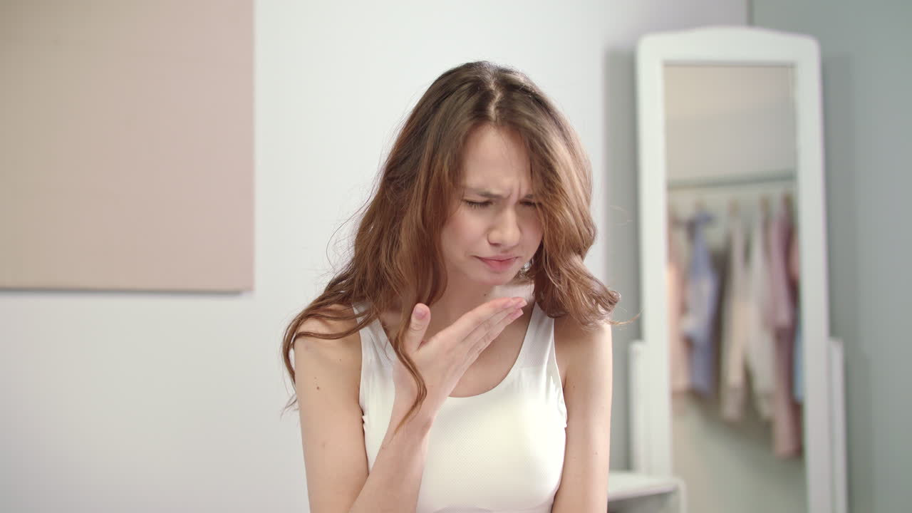 Flu woman feeling throat pain at morning. Sick woman touching sore neck in bed