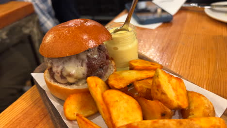 delicious gourmet burger with potato wedges and mayo