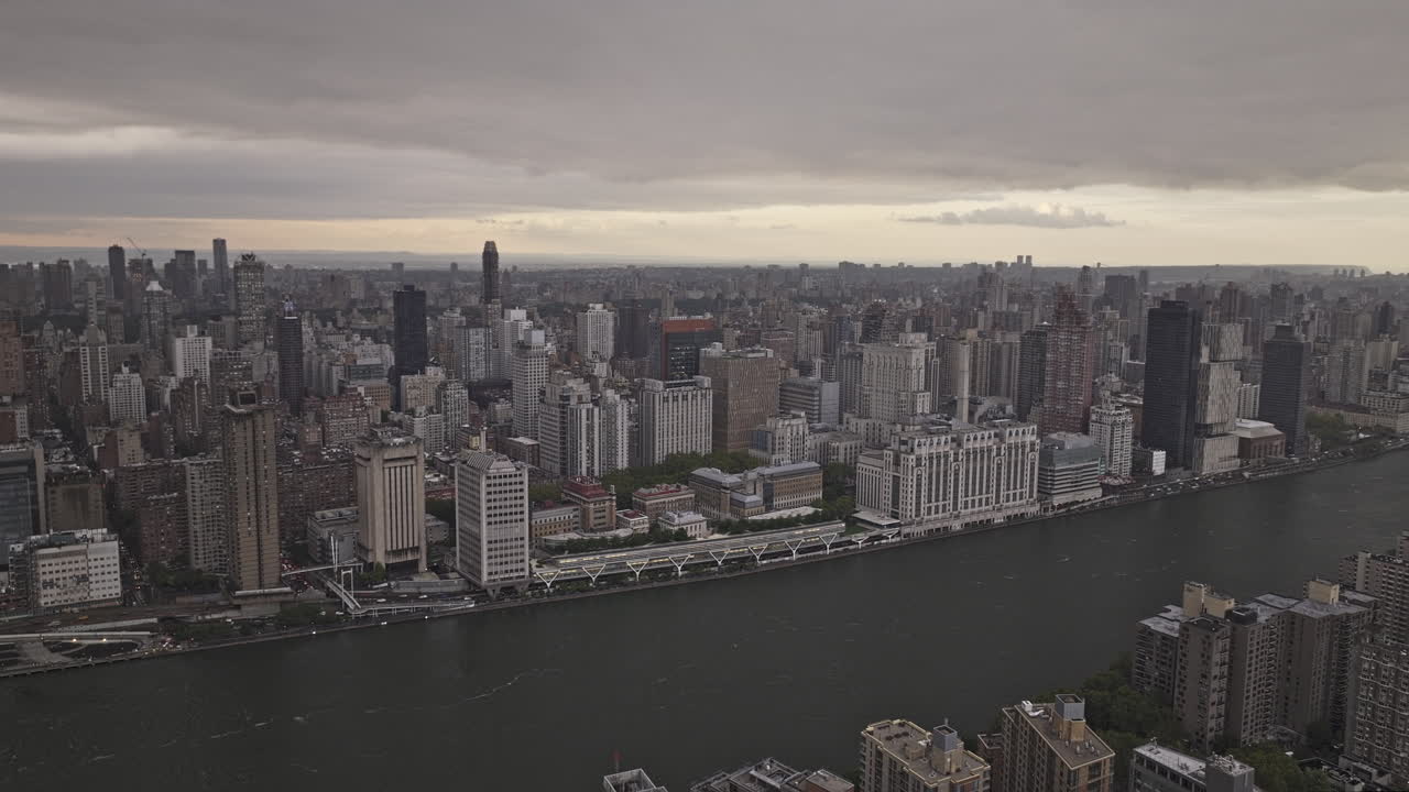 NYC New York Aerial v323 drone flyover East river and Roosevelt Island capturing Upper East Side and Midtown Manhattan cityscape against ominous cloud sky - Shot with Mavic 3 Pro Cine - September 2023