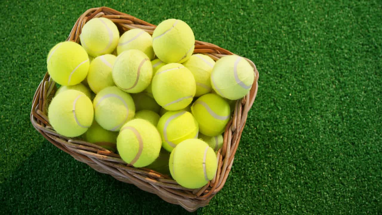 Tennis balls in wicker basket at studio 4k