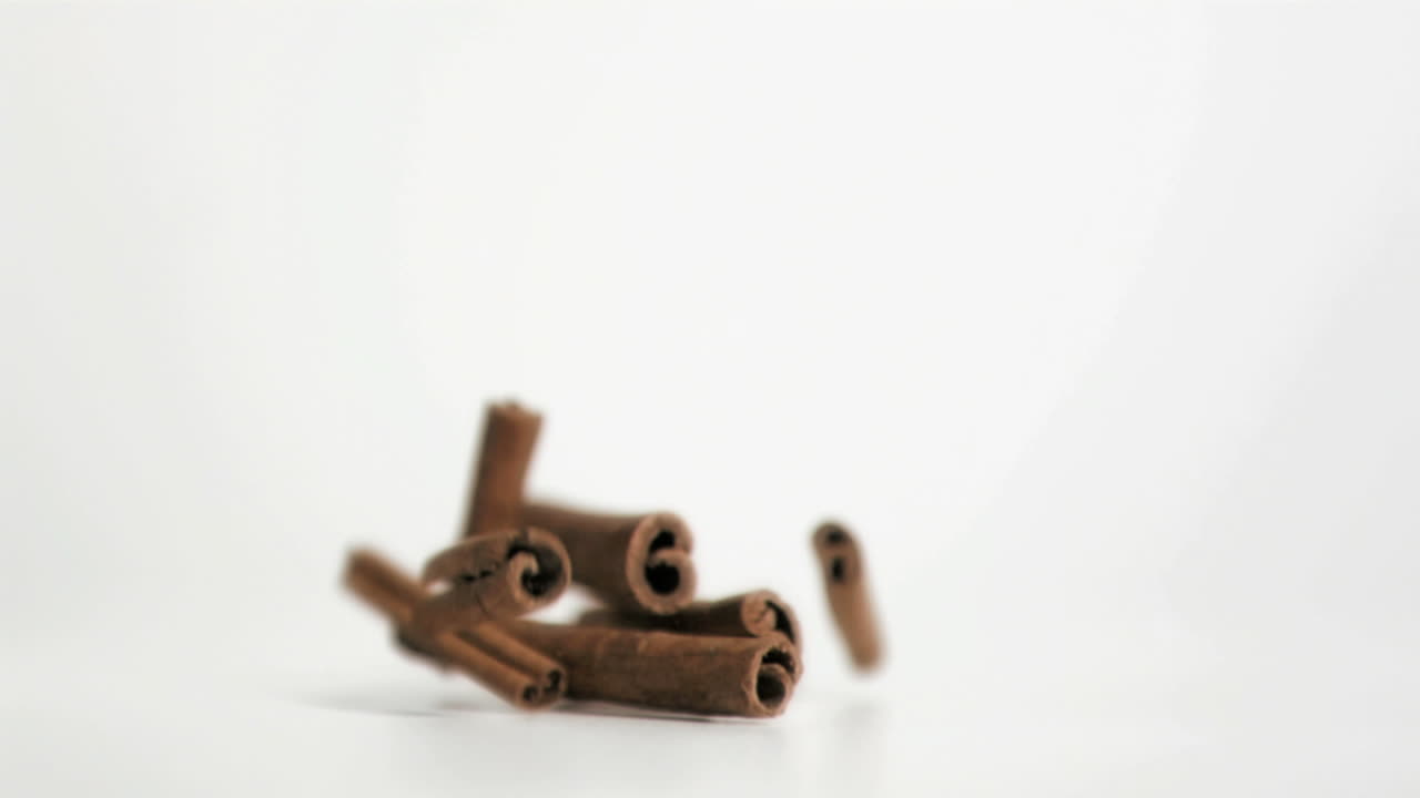 Cinnamon sticks falling in super slow motion