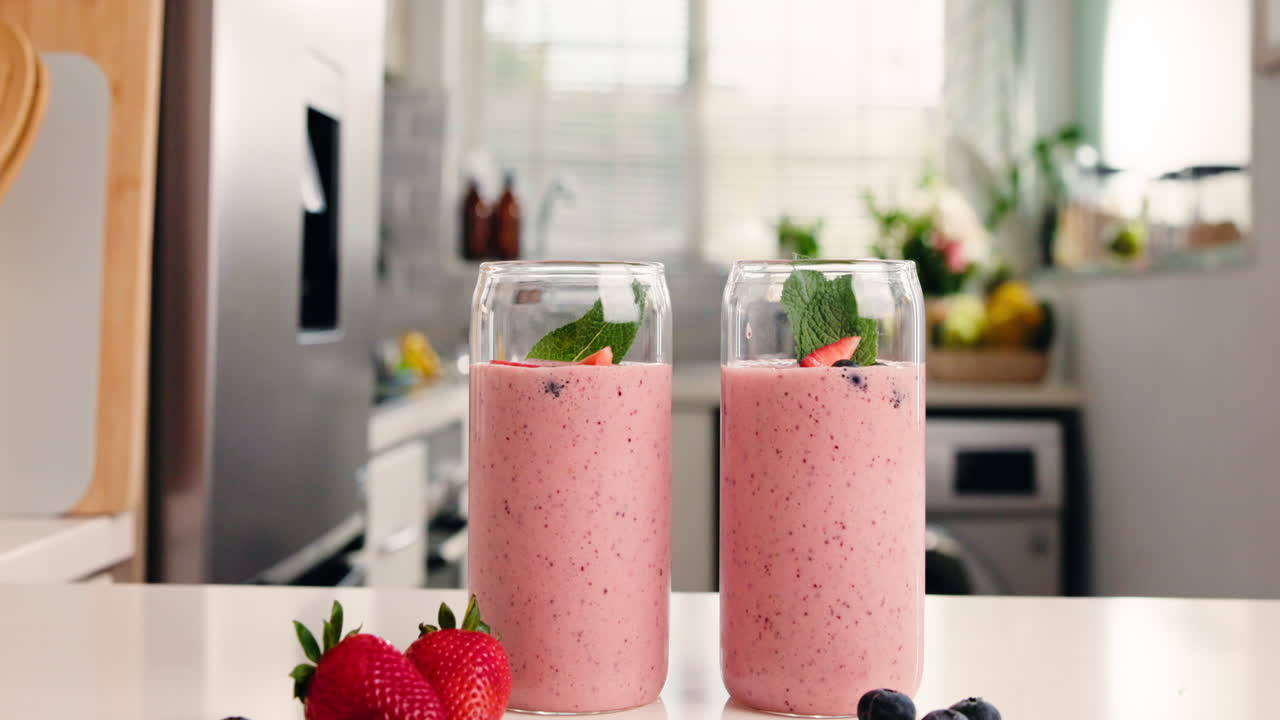 Two Glasses of Fresh Berry Smoothie on a Kitchen Counter
