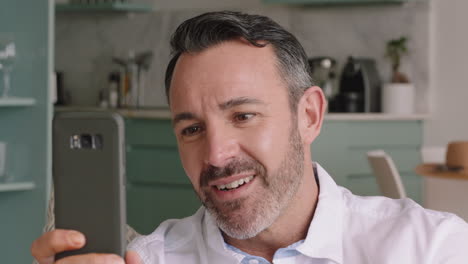 attractive man having video chat holding smartphone using sign language waving enjoying connection chatting on mobile phone