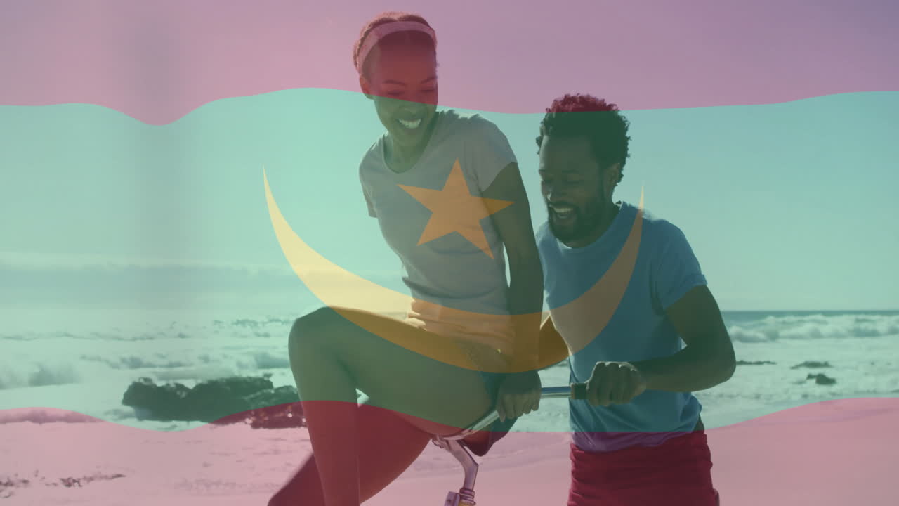 Riding bicycles on beach, couple with Mauritania flag animation overlay