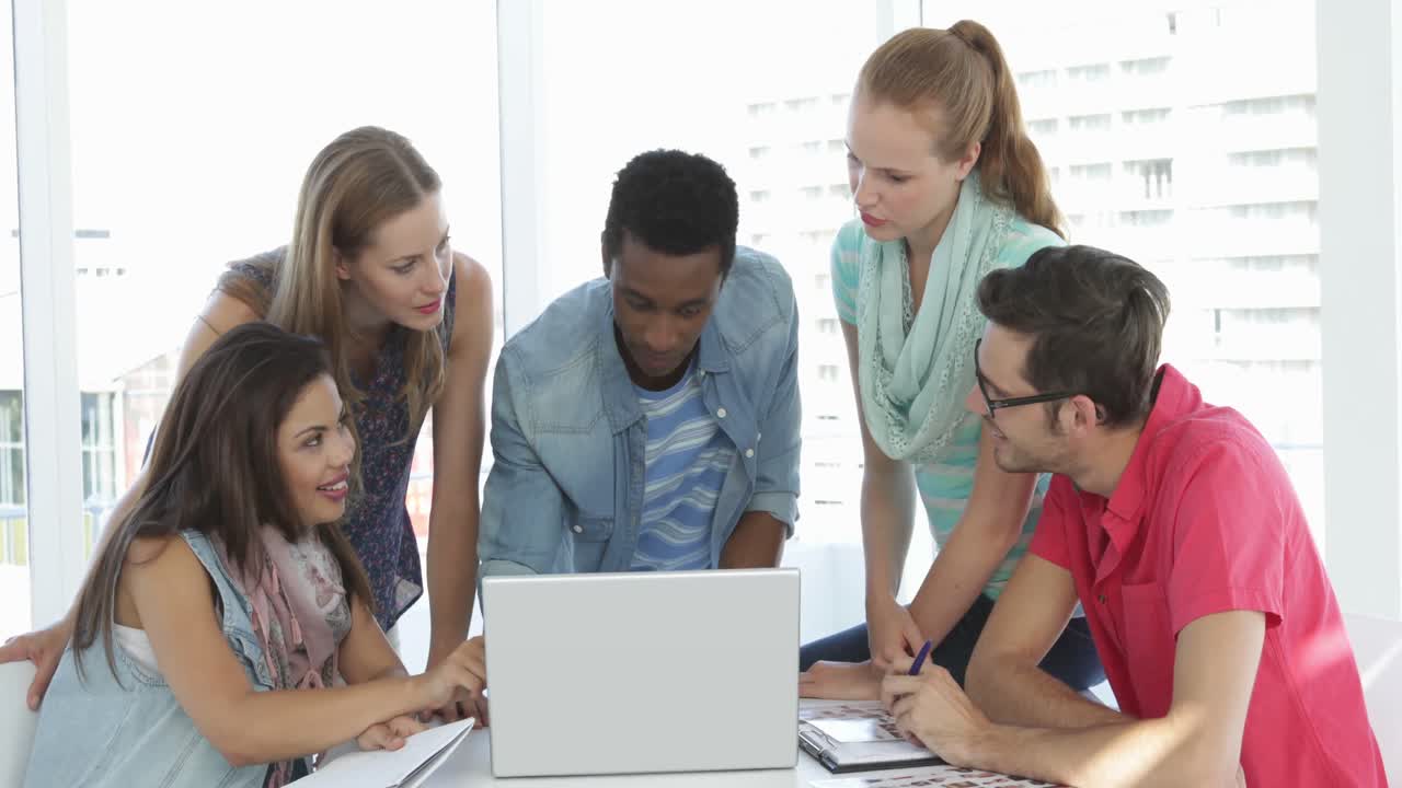 Creative team having a meeting using a laptop