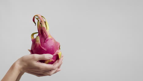 dragon fruit held in hands