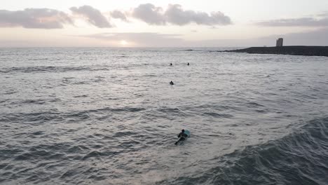 Surfers-surfing-at-Þorlákshöfn-surf-spot-in-cold-Icelandic-ocean-water