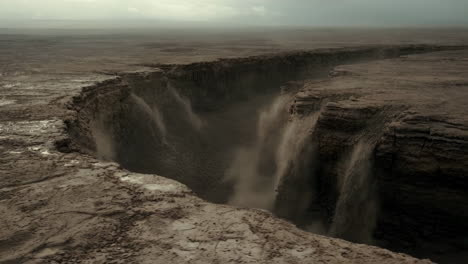 dramatic barren canyon with cascading dust or waterfalls