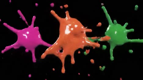 colorful paint splashes on black background