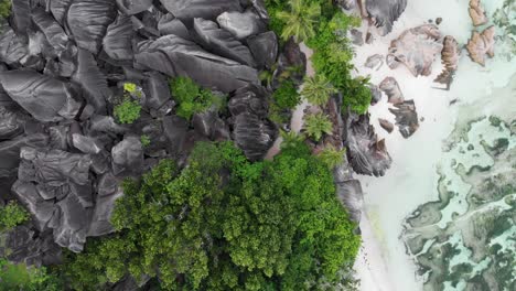 Aerial-view-of-Anse-Source-d’Argent,-La-Digue,-Seychelles-shot-in-the-early-morning-hours-with-no-people-on-the-beach