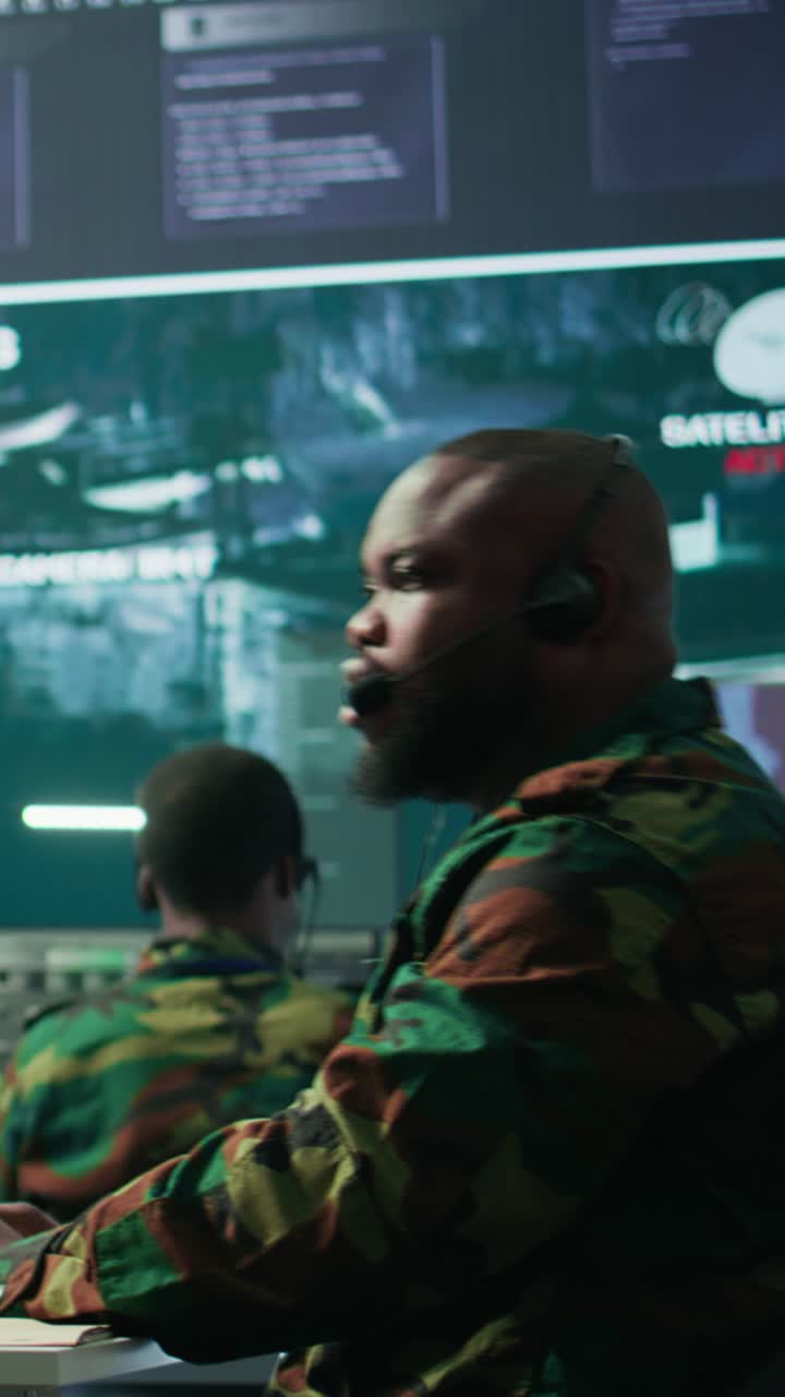 Vertical Video Government intelligence officer in high tech command post oversee satellite data