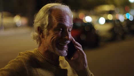 senior man talking on mobile phone in the city 4k