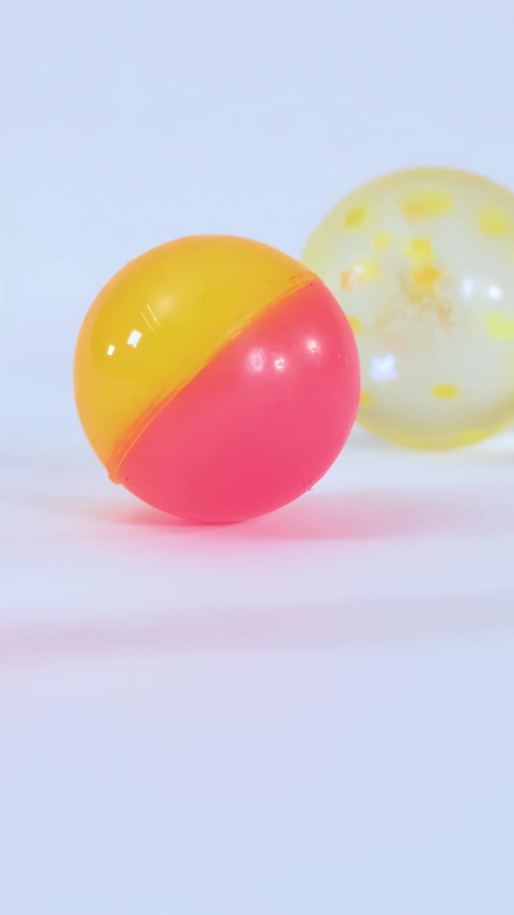 Colorful Bouncy Balls Falling and Bouncing on White Background