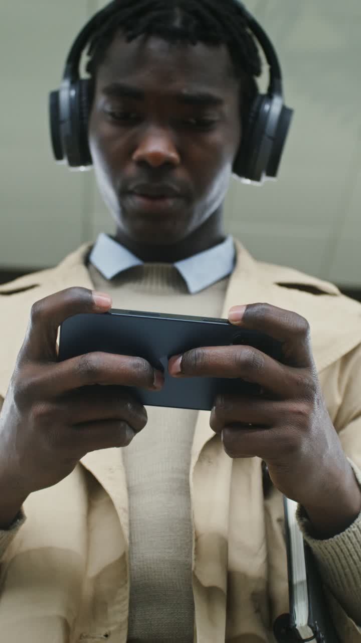 Man using mobile phone with headphones
