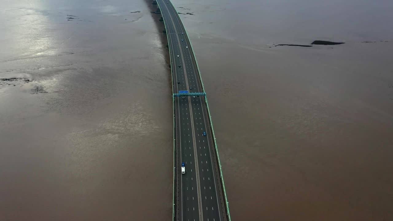 Aerial view of the Second Severn Bridge connecting England to Wales with tilt up view towards England