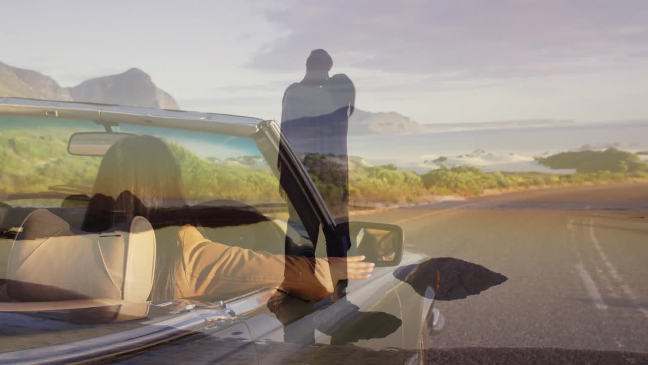 In convertible, couple embracing driving through picturesque landscape with animation
