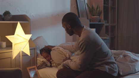 father putting kids to sleep