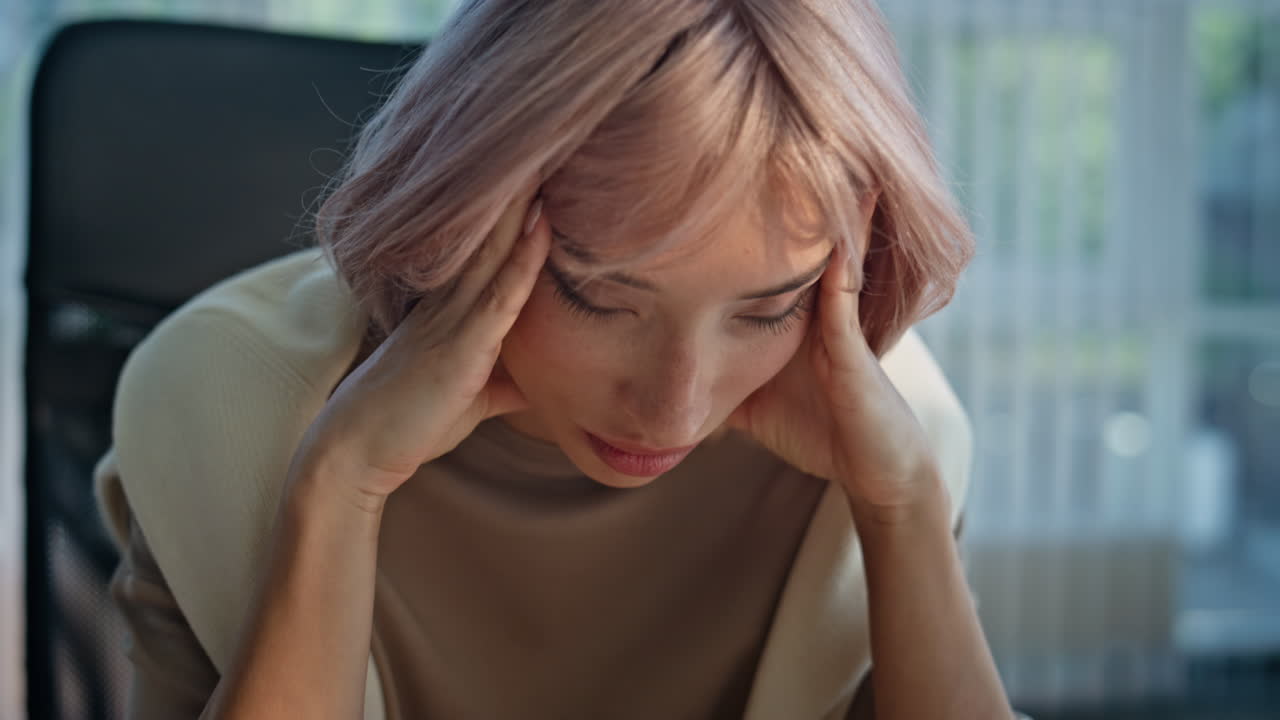 Exhausted manager suffer headache in office closeup. Tired woman having migraine