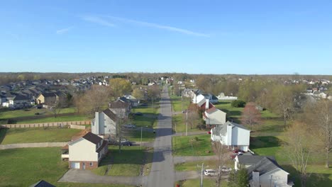 flying down a suburban street during a bright, blue skied day