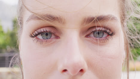 Close-up-video-portrait-of-eyes-of-caucasian-woman-smiling-outdoors