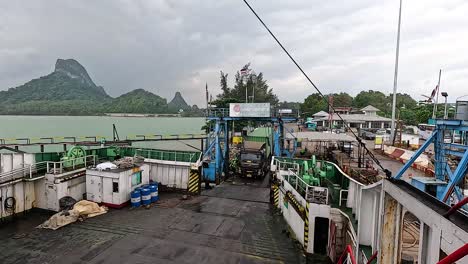 Truck boards ferry with scenic island backdrop