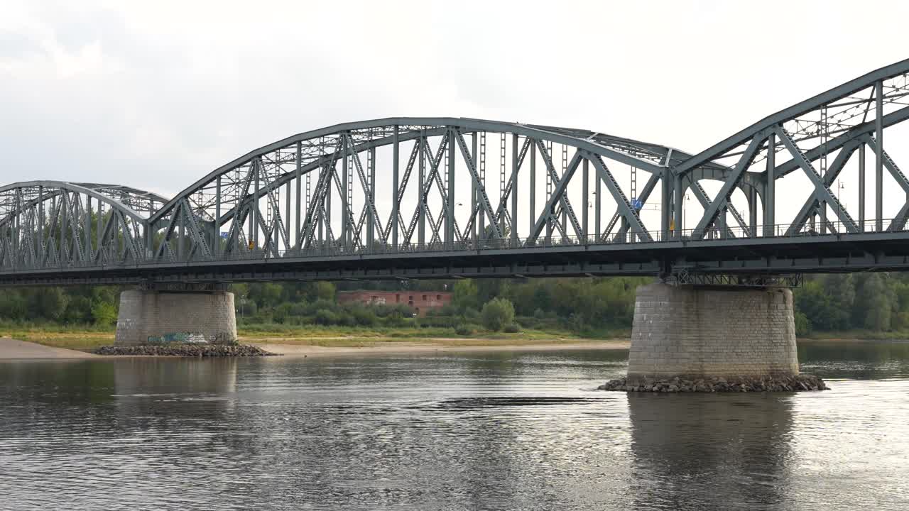 Old historic bridge in Torun. Steel truss bridge with concrete pillars in Poland