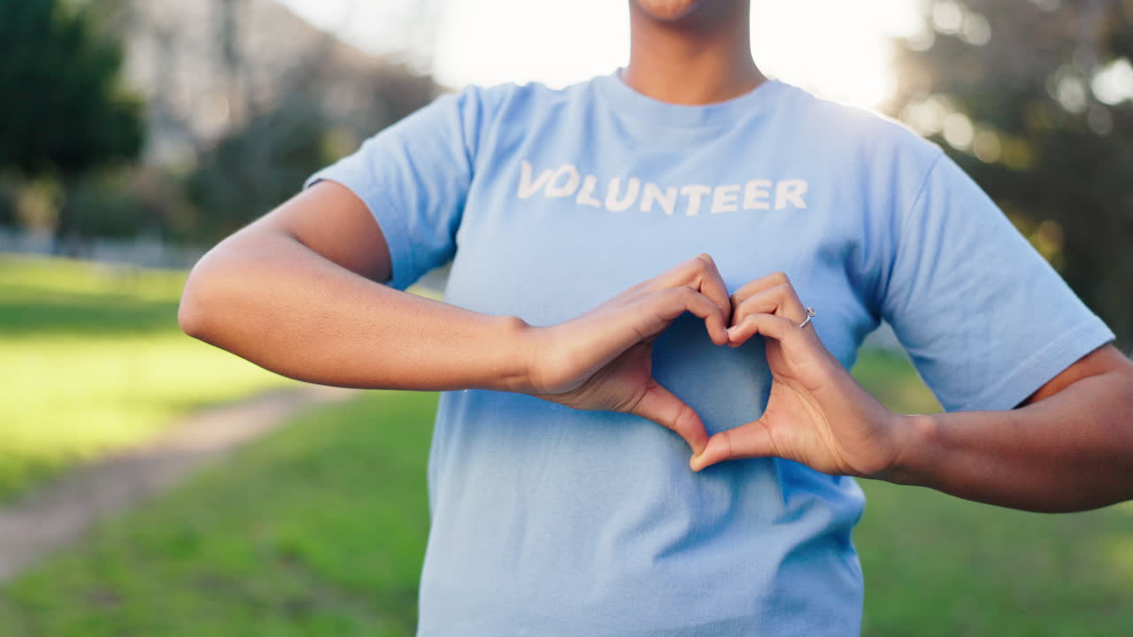 Volunteer making a heart shape with hands