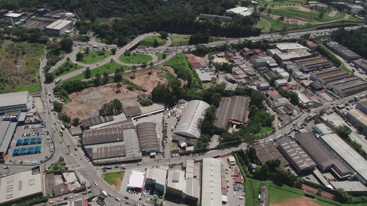 Aerial View of a Bustling Urban Industrial Area with Highway Interchange