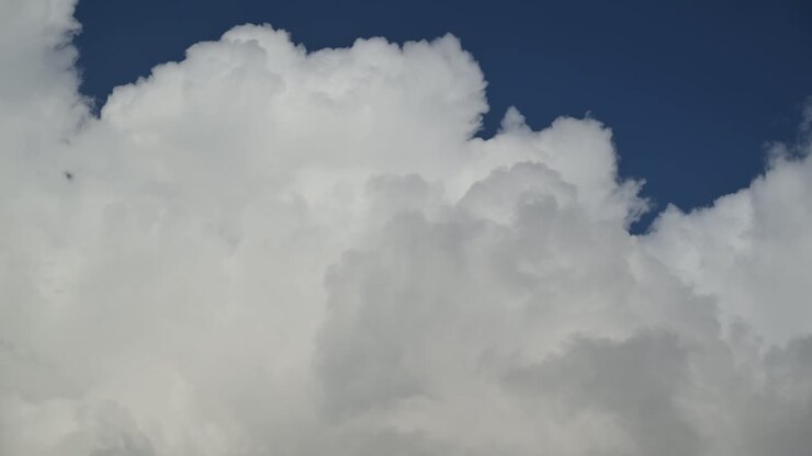 Time lapse video of clouds moving against the blue sky