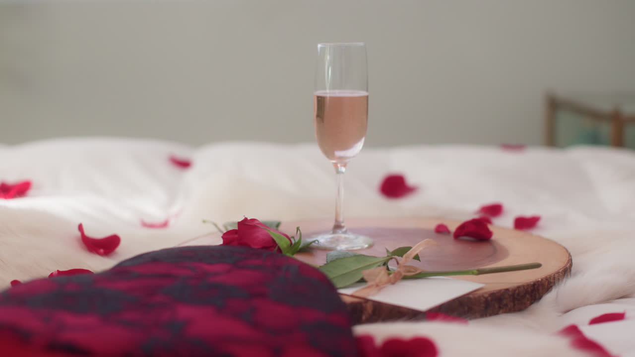 Woman's hand grabbing sparkling rose wine glass for Valentine's Day close up