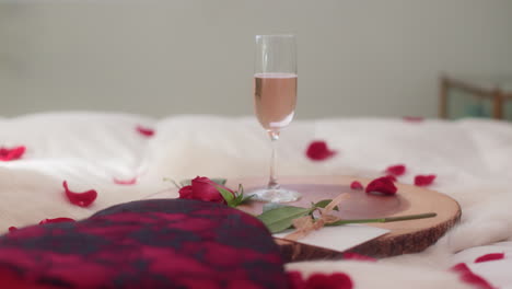 Woman's-hand-grabbing-sparkling-rose-wine-glass-for-Valentine's-Day-close-up